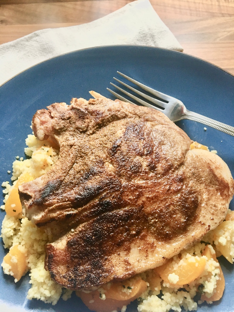 North African Flavored Pork Chops served over a bed of apricot couscous, makes a delicious but fast and easy mid-week supper!